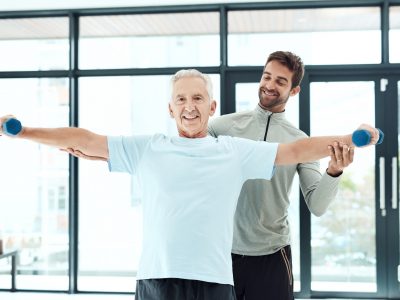 I’m working on being more independent Shot of a friendly physiotherapist helping his senior patient work out with weights